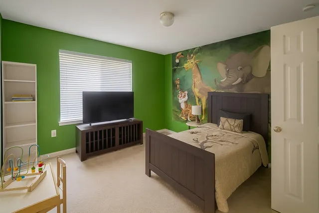 a bedroom with a bed and a flat screen tv