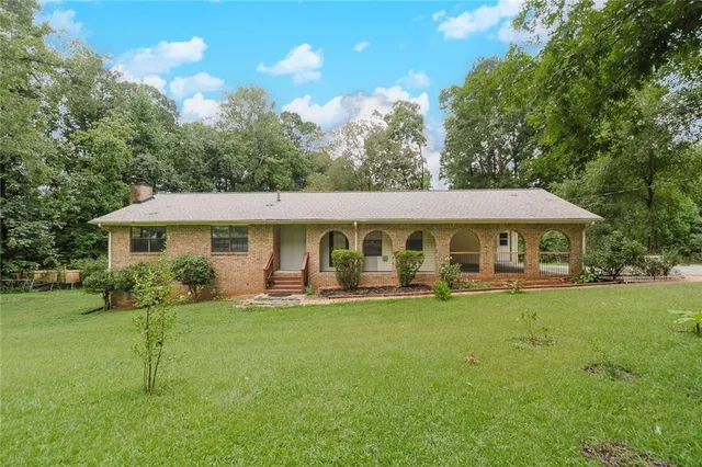 a front view of a house with garden