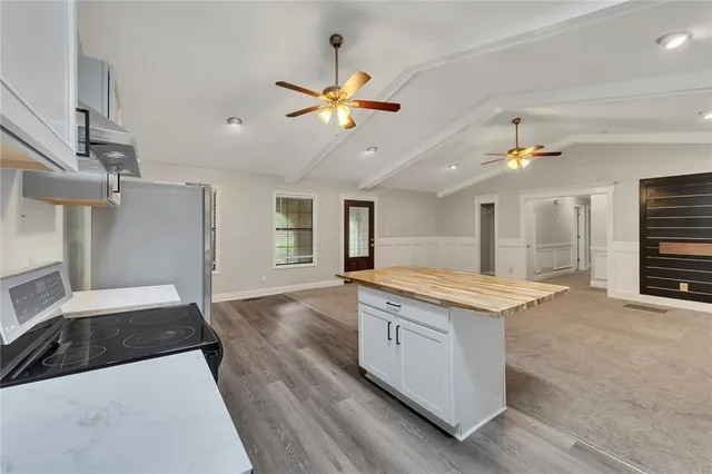 a view of a hallway with wooden floor and entryway