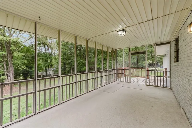 a view of a porch with wooden floor and roof