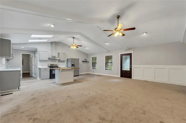 a view of a kitchen with a sink and a refrigerator