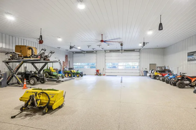a living room with furniture a fireplace and a chandelier
