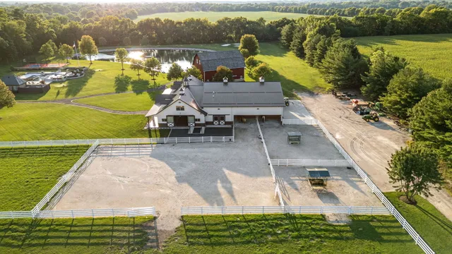 a living room with furniture a fireplace and a chandelier