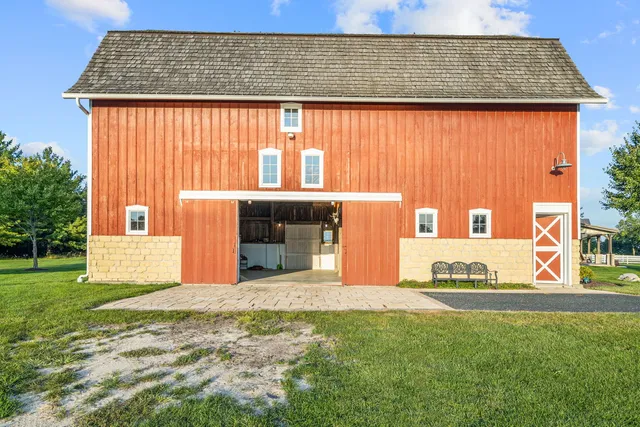a view of a dining room with furniture a chandelier and wooden floor