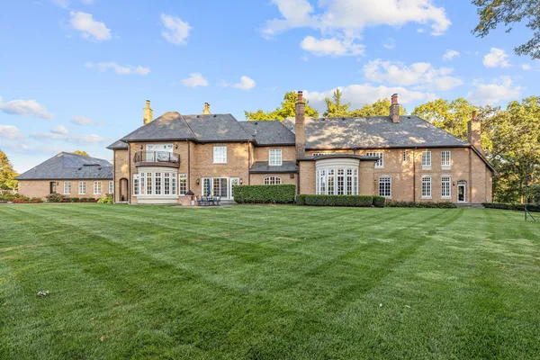 a kitchen with stainless steel appliances granite countertop a stove a sink dishwasher and white cabinets with wooden floor