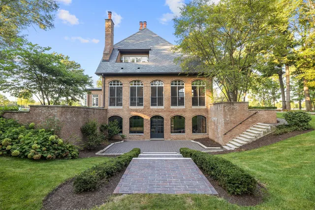 a kitchen with stainless steel appliances granite countertop a stove a kitchen island a dining table and chairs with wooden floor