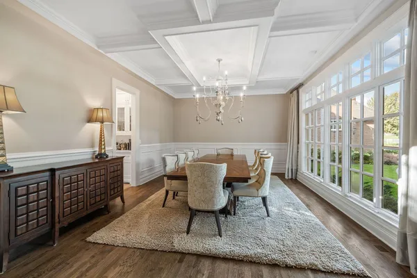 a living room with fireplace furniture and a chandelier
