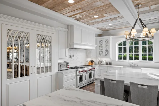 a view of staircase with lots of frames on wall and wooden floor
