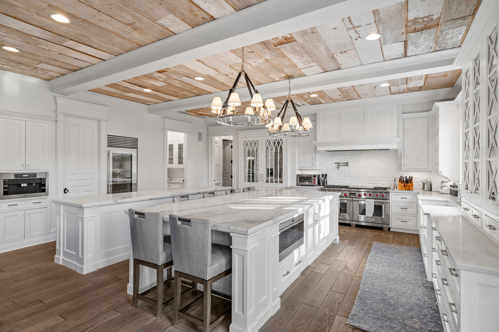 5021 Minkler Road Yorkville, IL 60560 - Photo 31 of 92 a kitchen with stainless steel appliances a stove a sink dishwasher and white cabinets with wooden floor