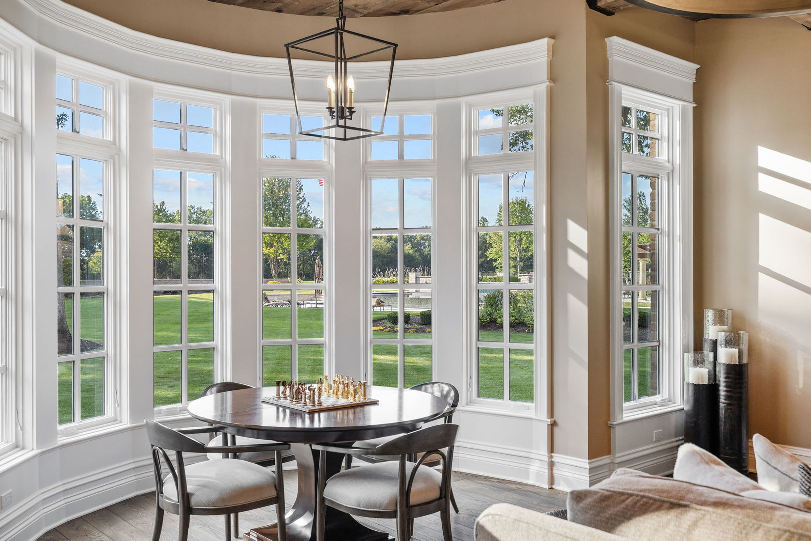 5021 Minkler Road Yorkville, IL 60560 - Photo 37 of 92 a dining room with wooden floor a chandelier a glass table and chairs