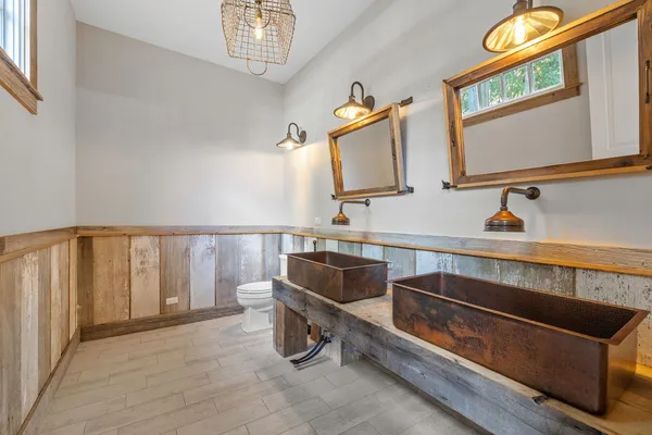 a large room with lots of wooden furniture and a rug