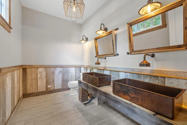 a large room with lots of wooden furniture and a rug