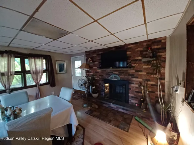 a living room with furniture a flat screen tv and a floor to ceiling window