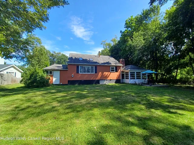 a view of a house with a backyard