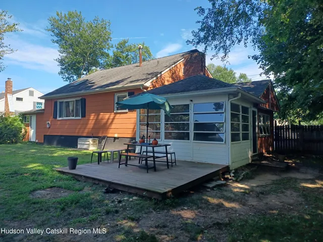 a view of a house with a yard table and chairs