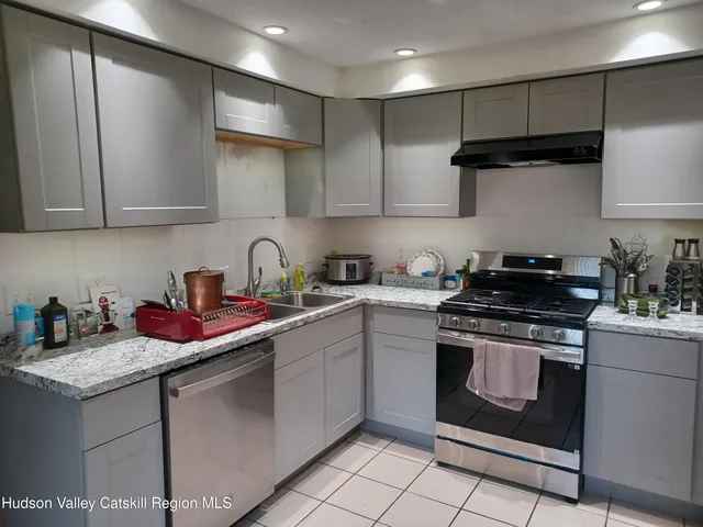 a kitchen with stainless steel appliances granite countertop a sink stove and cabinets