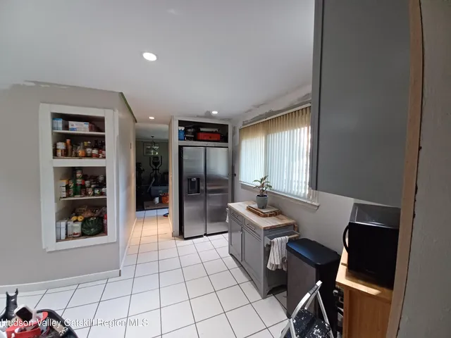 a view of a workspace with furniture and window