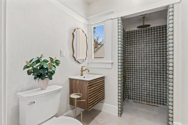 a bathroom with a sink toilet and a mirror