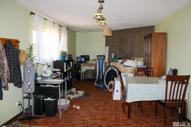 a living room with furniture fireplace and a large window