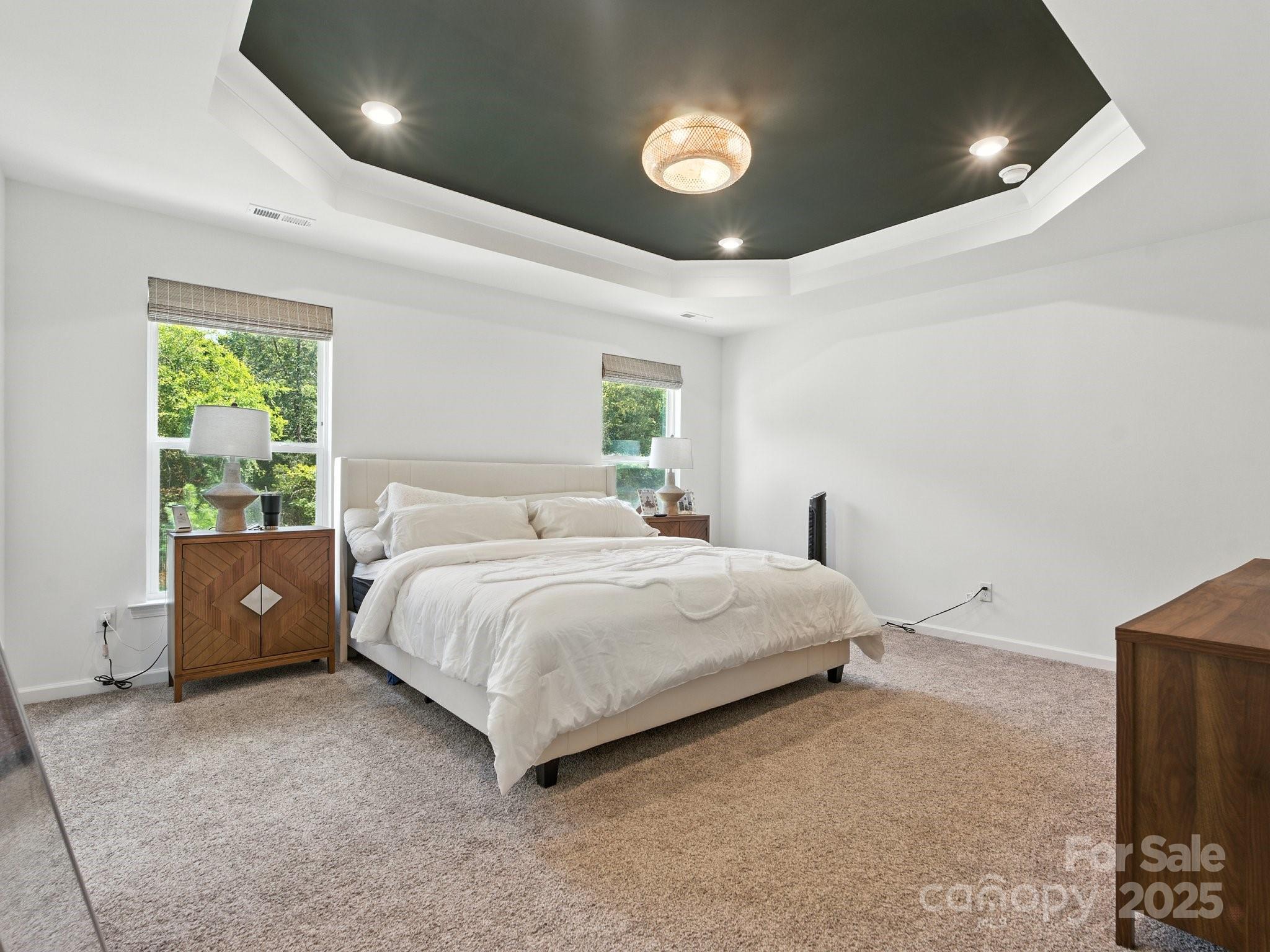 13156 Rover Street Charlotte, NC 28273 - Photo 22 of 37 a spacious bedroom with a bed and a large window