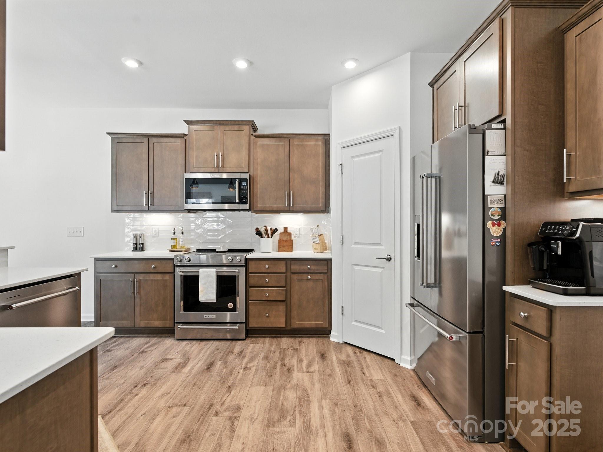13156 Rover Street Charlotte, NC 28273 - Photo 4 of 37 a kitchen with granite countertop a refrigerator stove top oven and sink