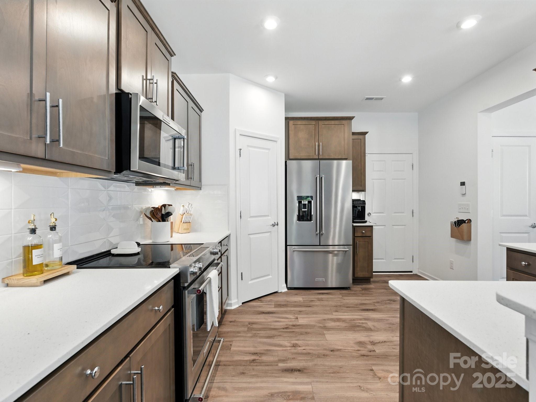 13156 Rover Street Charlotte, NC 28273 - Photo 6 of 37 a kitchen with a sink stove and refrigerator