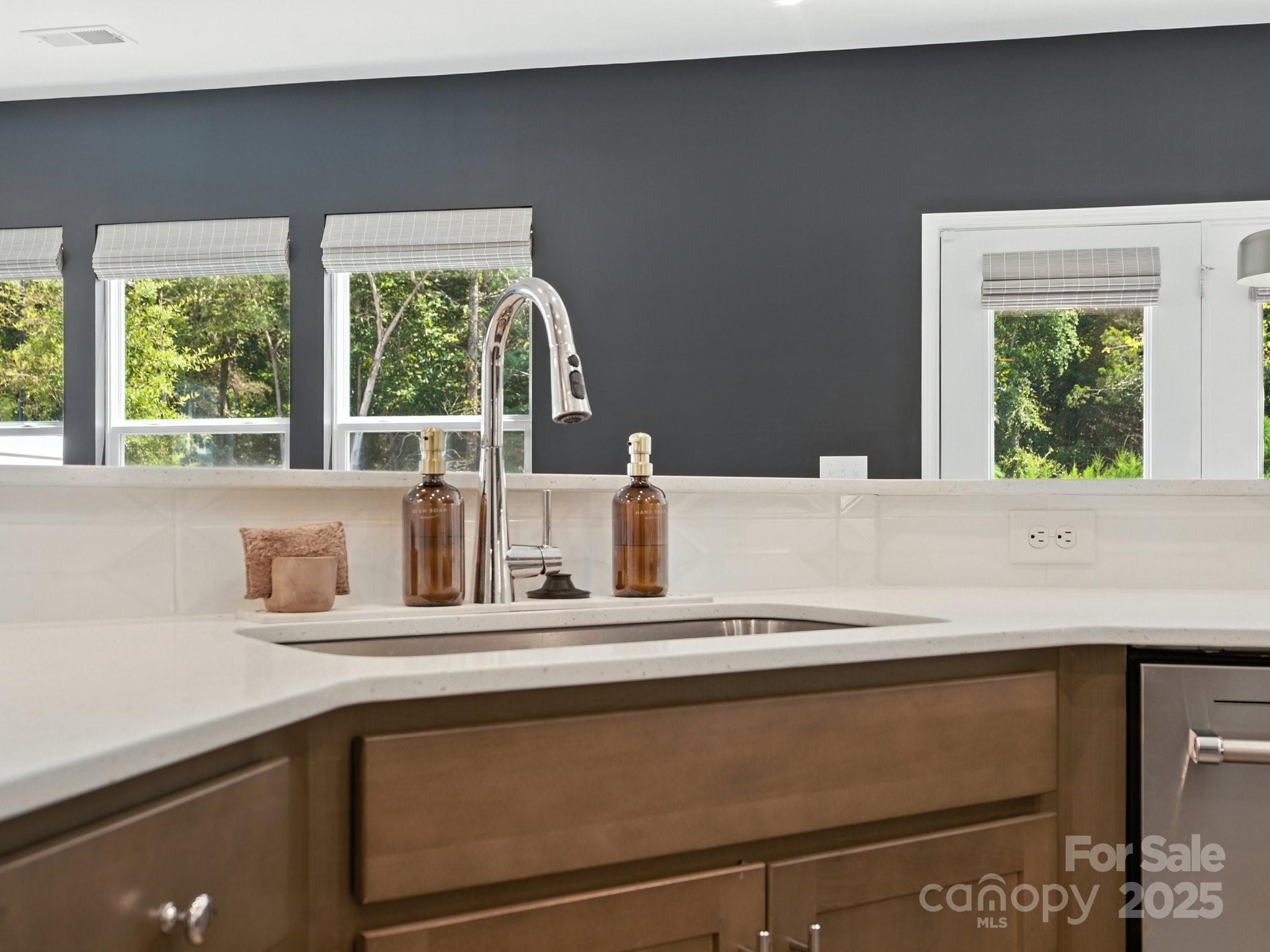 13156 Rover Street Charlotte, NC 28273 - Photo 8 of 37 a kitchen with a sink and a large window
