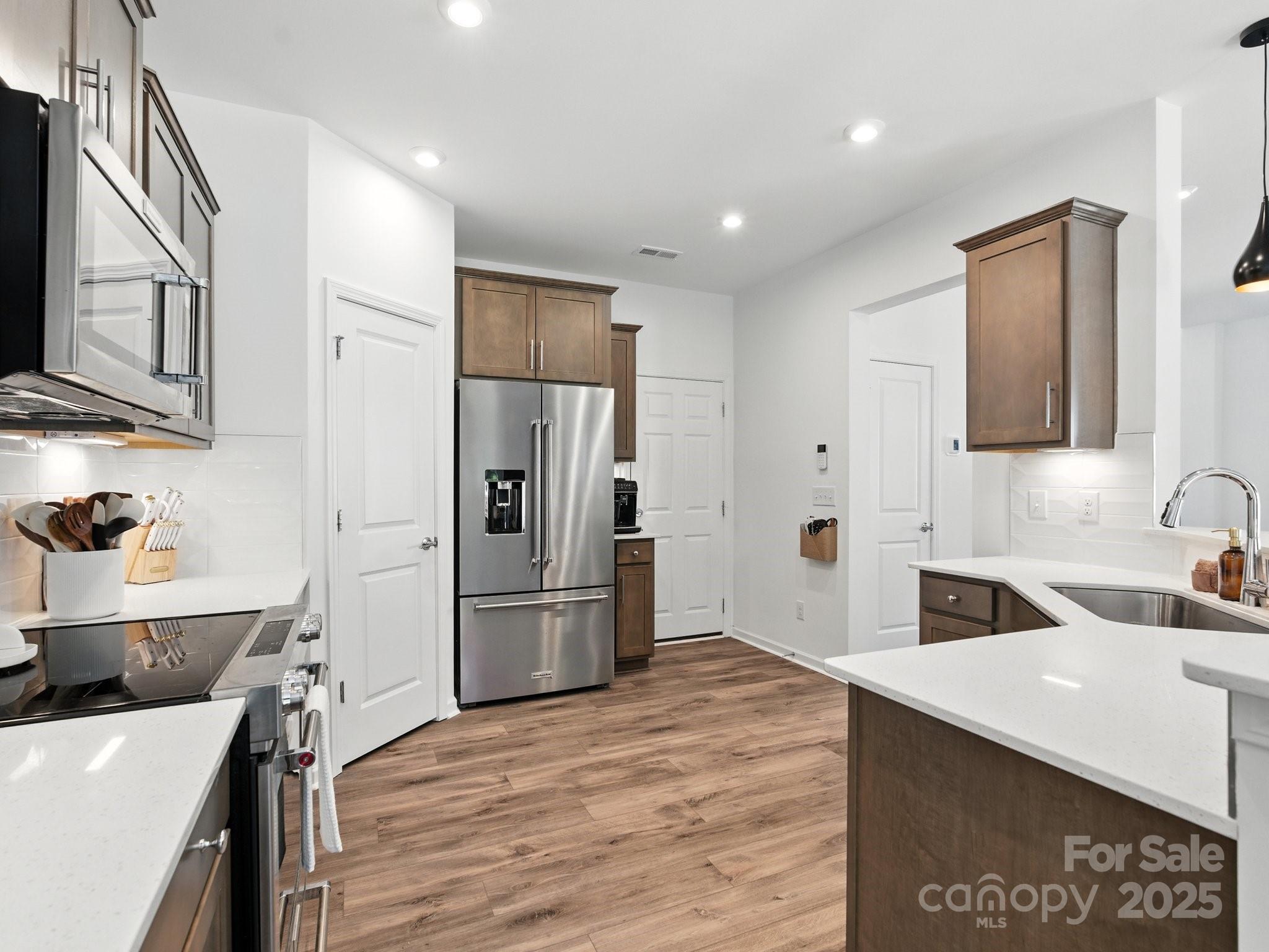 13156 Rover Street Charlotte, NC 28273 - Photo 9 of 37 a kitchen with a refrigerator and a sink