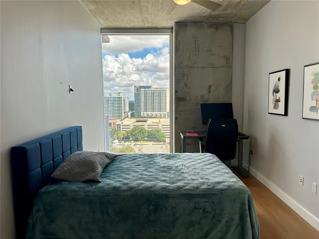 a bed sitting in a bedroom next to a window