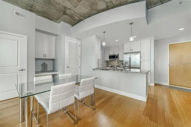a view of kitchen with cabinets microwave and stove