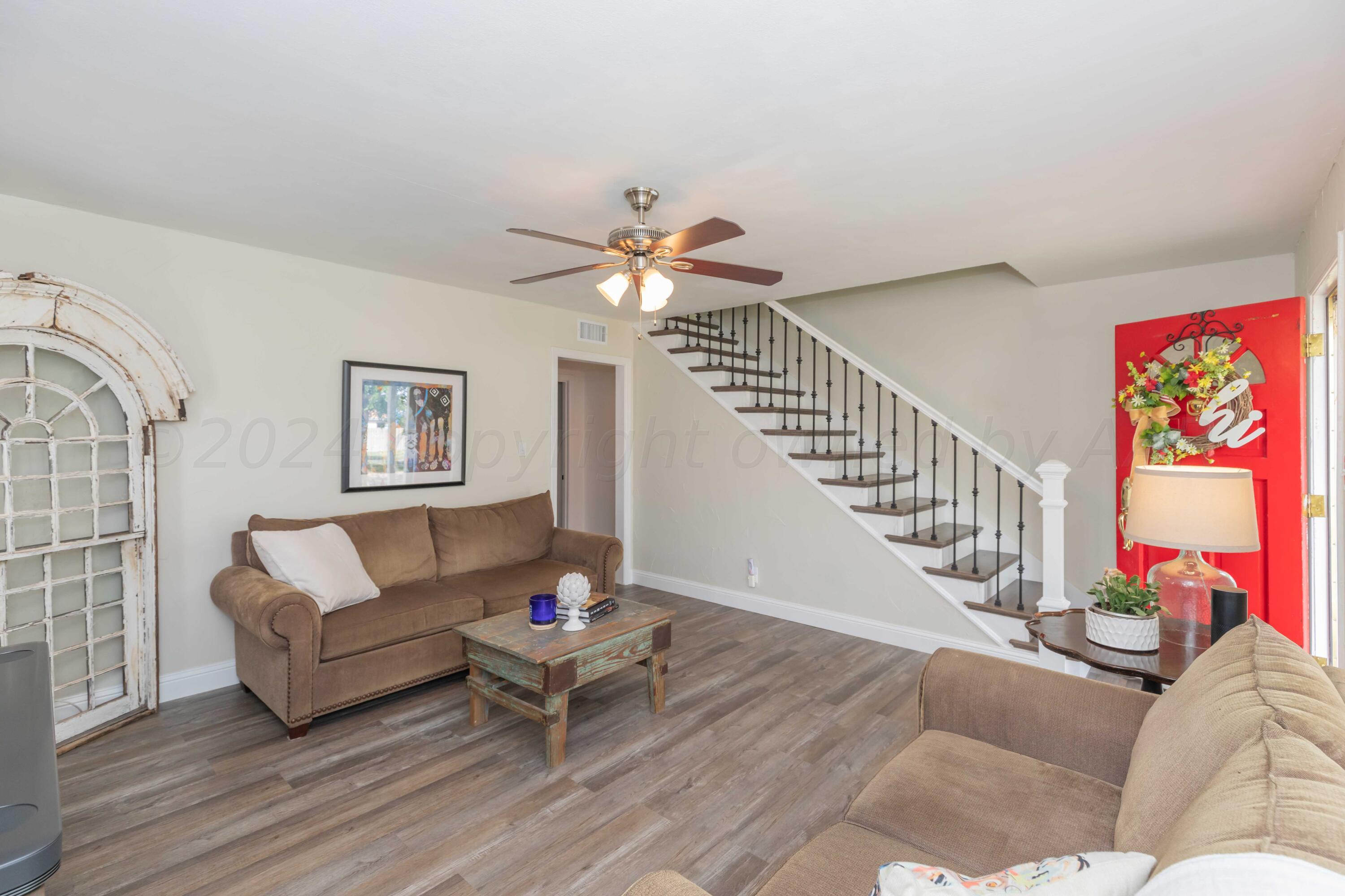 1007 South Alabama Street Amarillo, TX 79102 - Photo 11 of 55 a living room with furniture and a chandelier