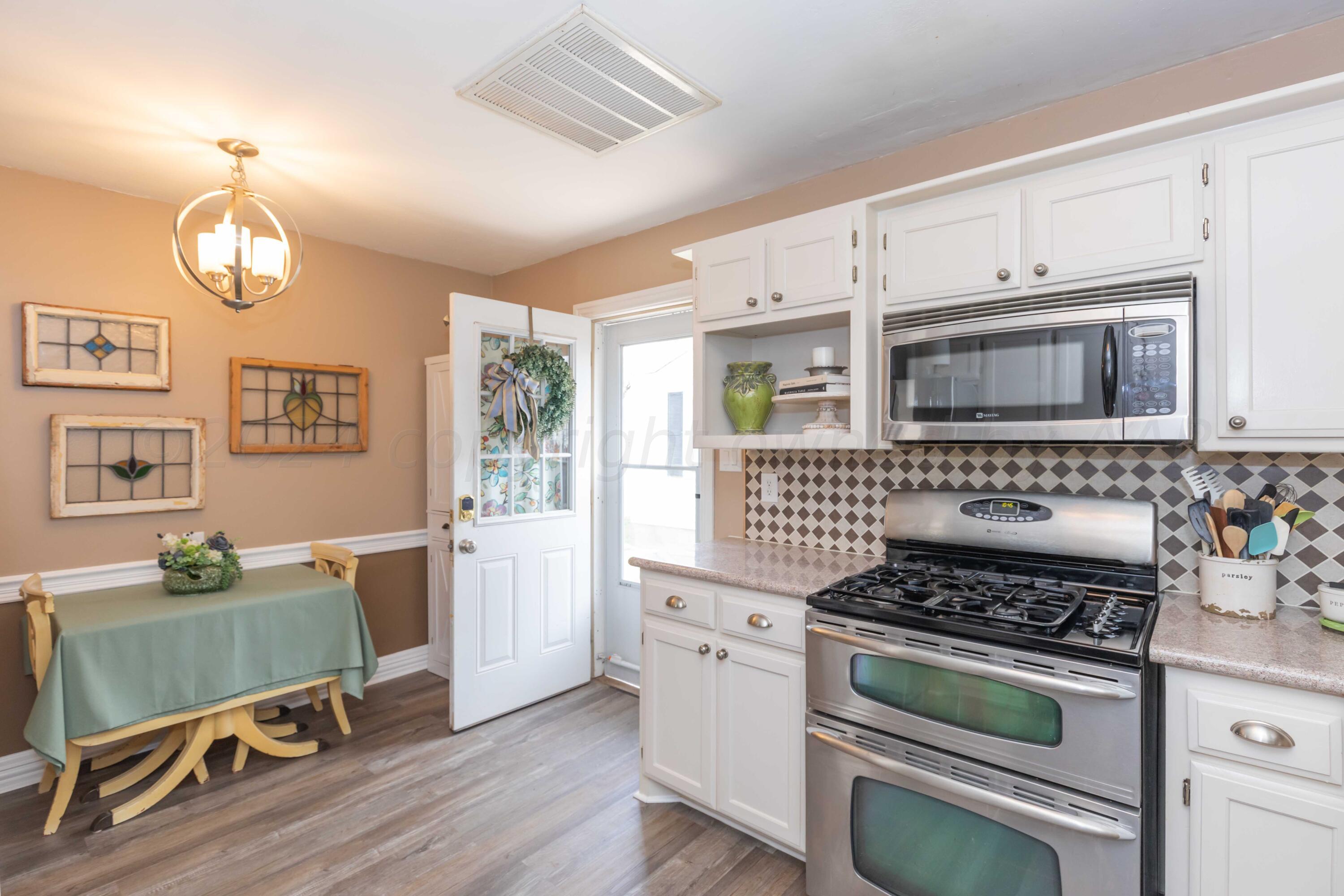 1007 South Alabama Street Amarillo, TX 79102 - Photo 16 of 55 a kitchen with a stove and a refrigerator