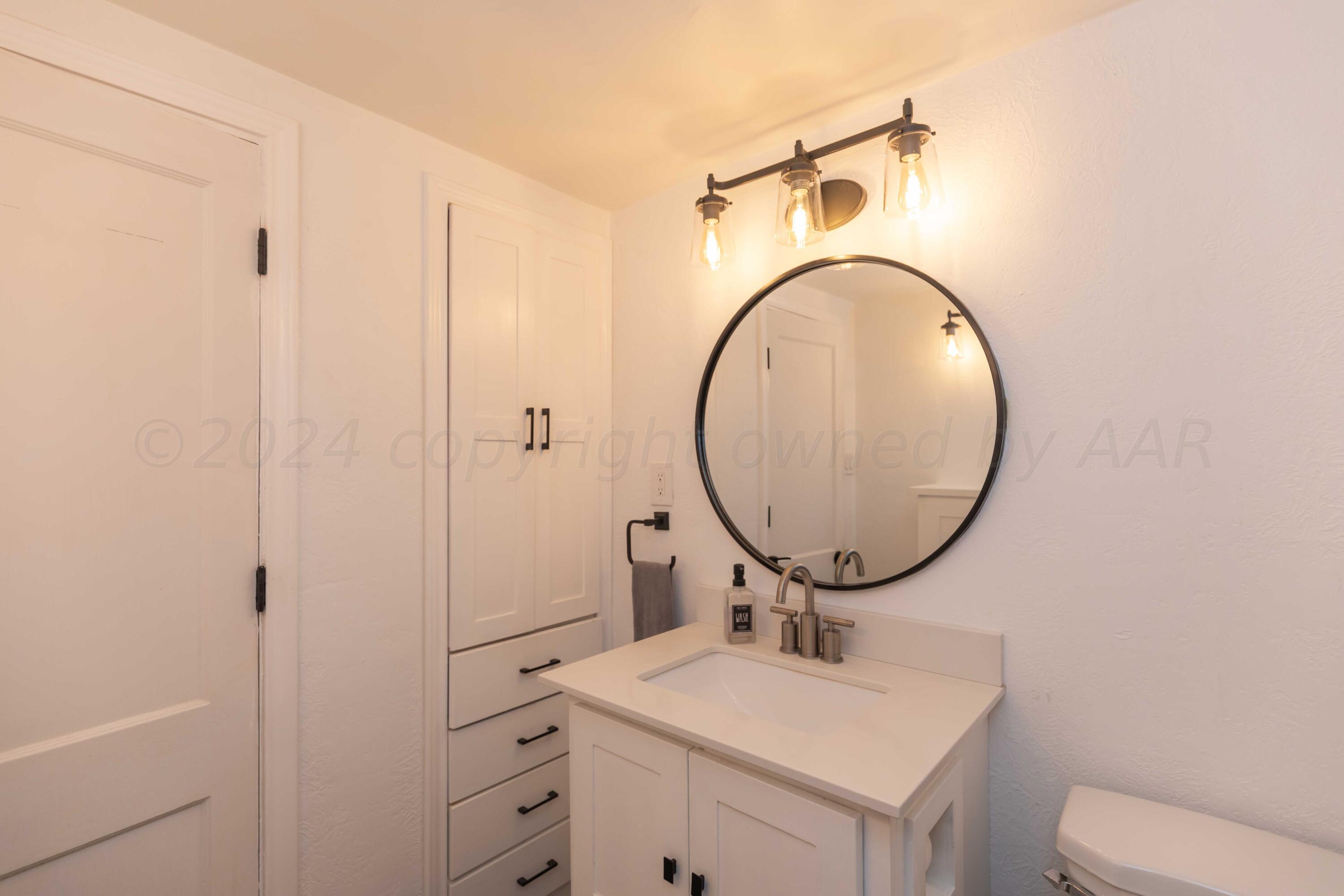 1007 South Alabama Street Amarillo, TX 79102 - Photo 21 of 55 a bathroom with a sink toilet and a mirror