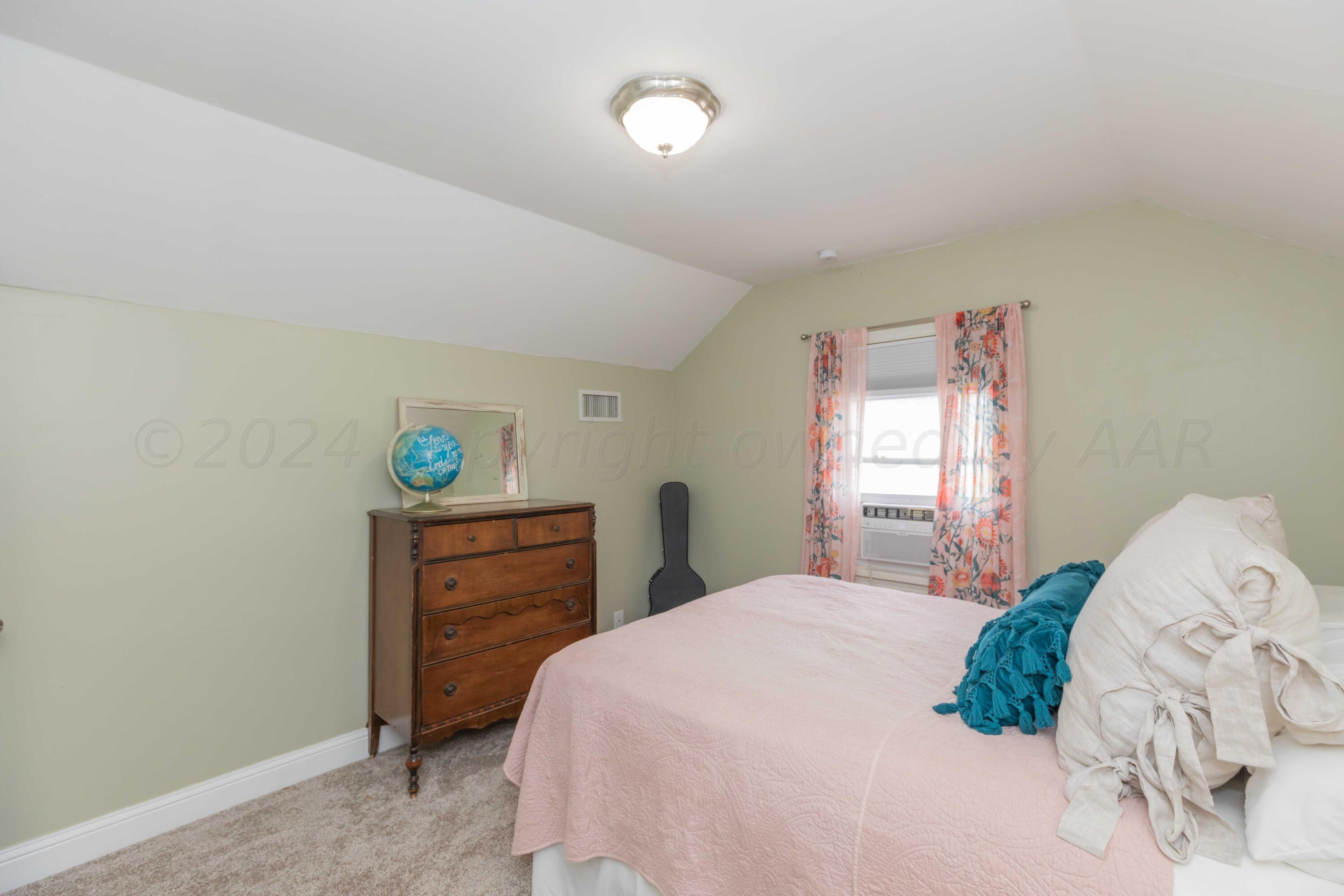 1007 South Alabama Street Amarillo, TX 79102 - Photo 27 of 55 a bedroom with a bed and a window