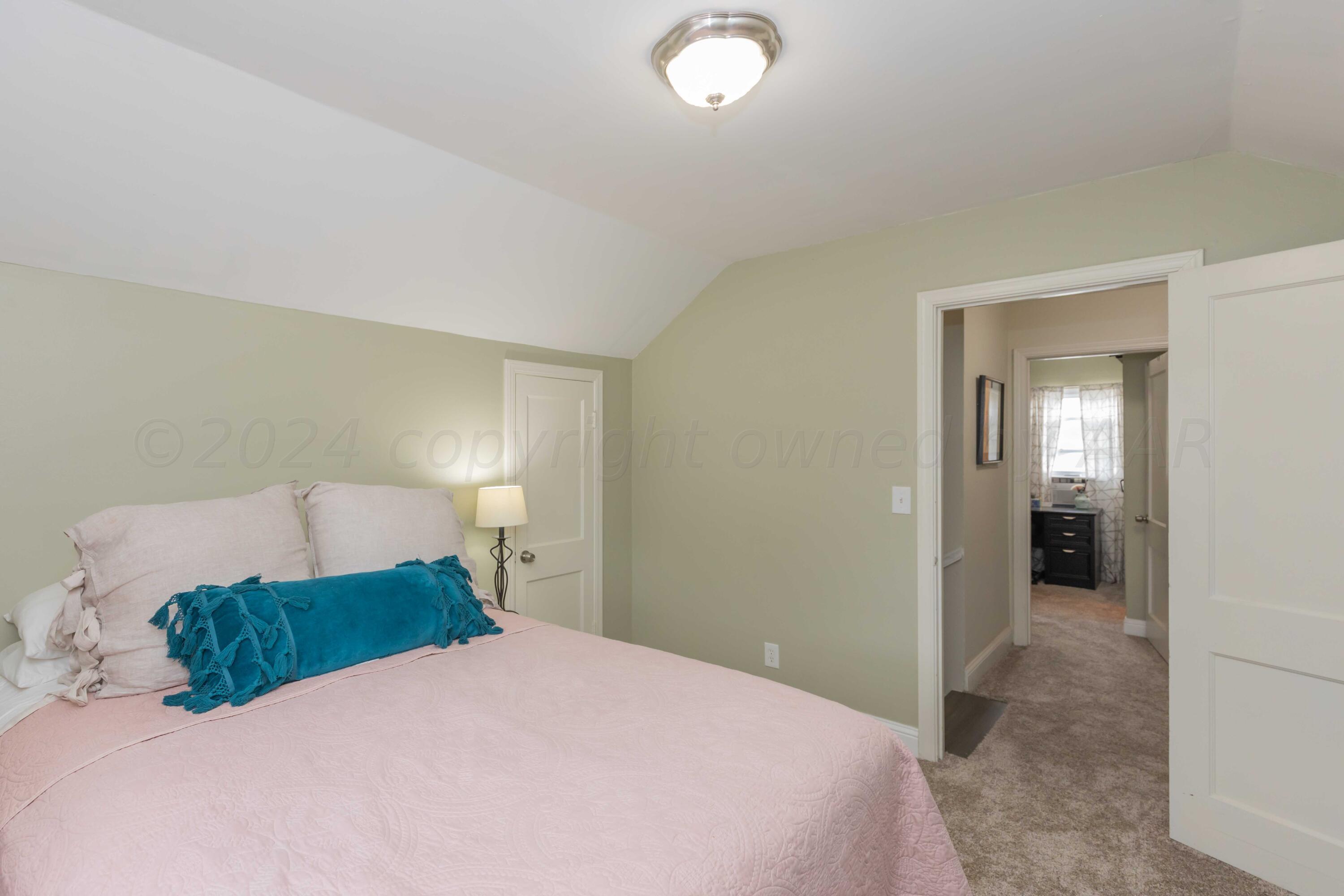 1007 South Alabama Street Amarillo, TX 79102 - Photo 28 of 55 a bedroom with a bed and a lamp