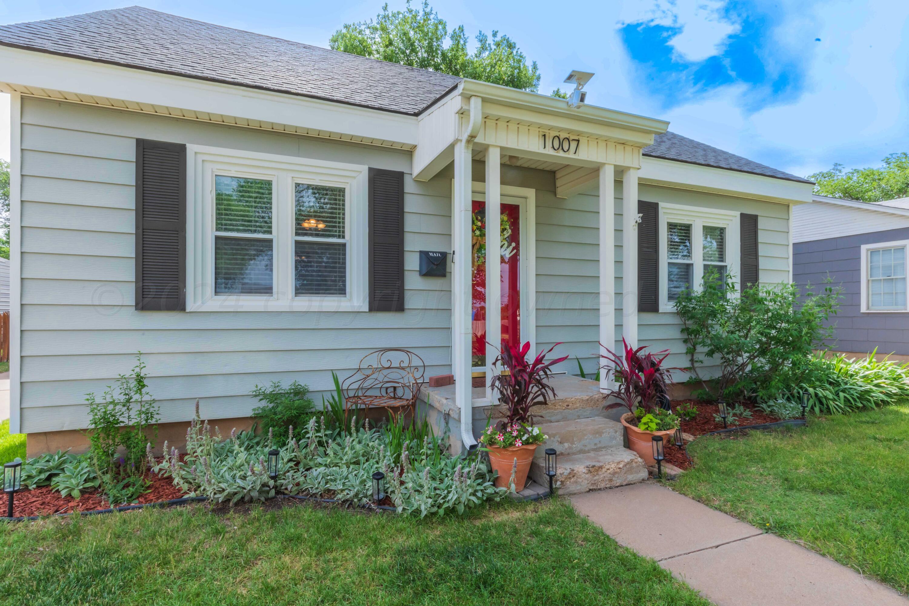 1007 South Alabama Street Amarillo, TX 79102 - Photo 6 of 55 a view of a house with a backyard and a garden