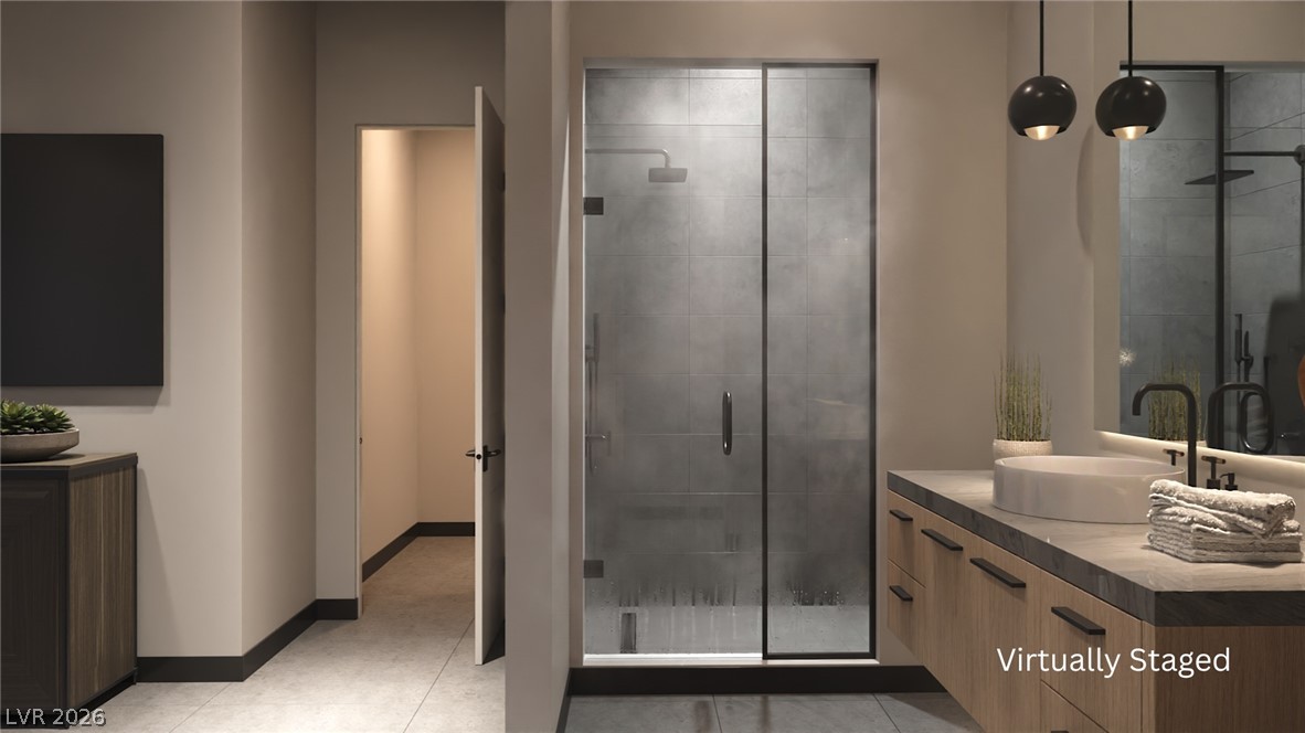 543 Overlook Rim Drive Henderson, NV 89012 - Photo 11 of 19 A guest bathroom features a spacious glass-enclosed shower and a sleek vanity with a modern vessel sink.