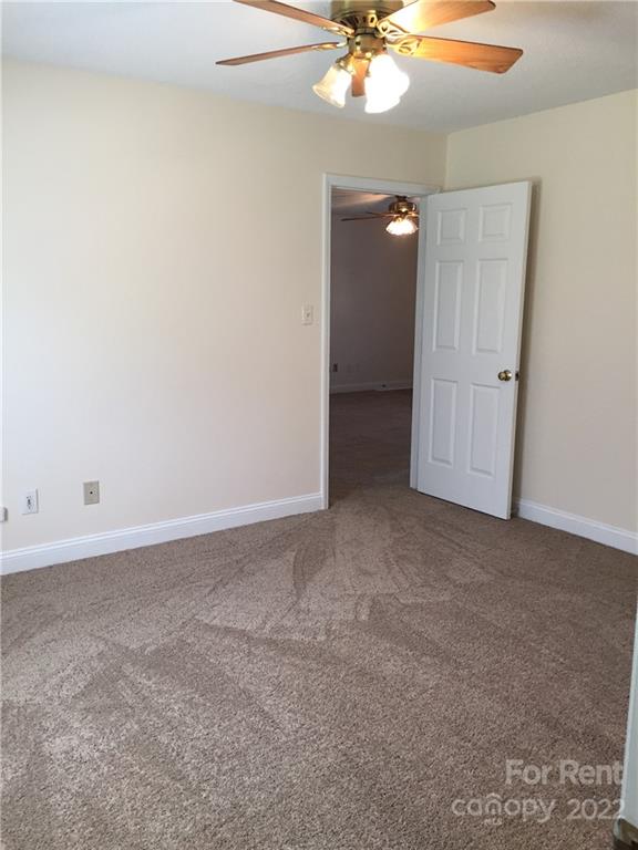 2296 Beth Haven Church Road, Unit 2296 Denver, NC 28037 - Photo 4 of 13 a view of an empty room with a chandelier fan