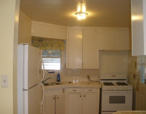 3618 Cypress Street Corpus Christi, TX 78411 - Photo 3 of 10 a kitchen with a sink a stove and cabinets