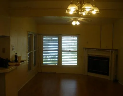 a view of empty room with window and fireplace
