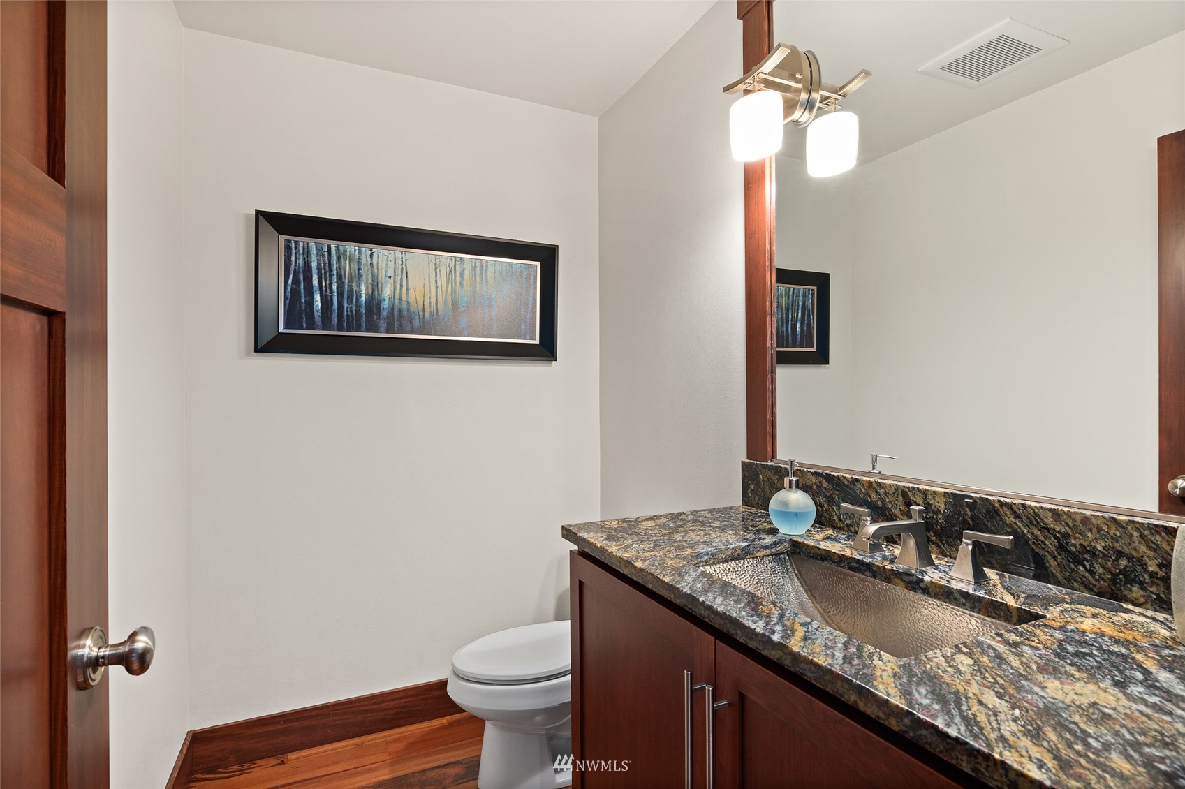 691 Kachess River Road Easton, WA 98925 - Photo 25 of 40 a bathroom with a granite countertop sink a toilet and mirror