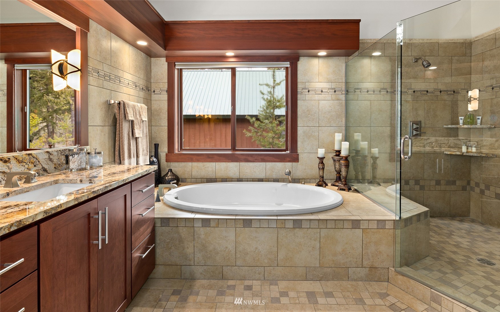 691 Kachess River Road Easton, WA 98925 - Photo 29 of 40 a bathroom with a granite countertop sink a large mirror and a bathtub