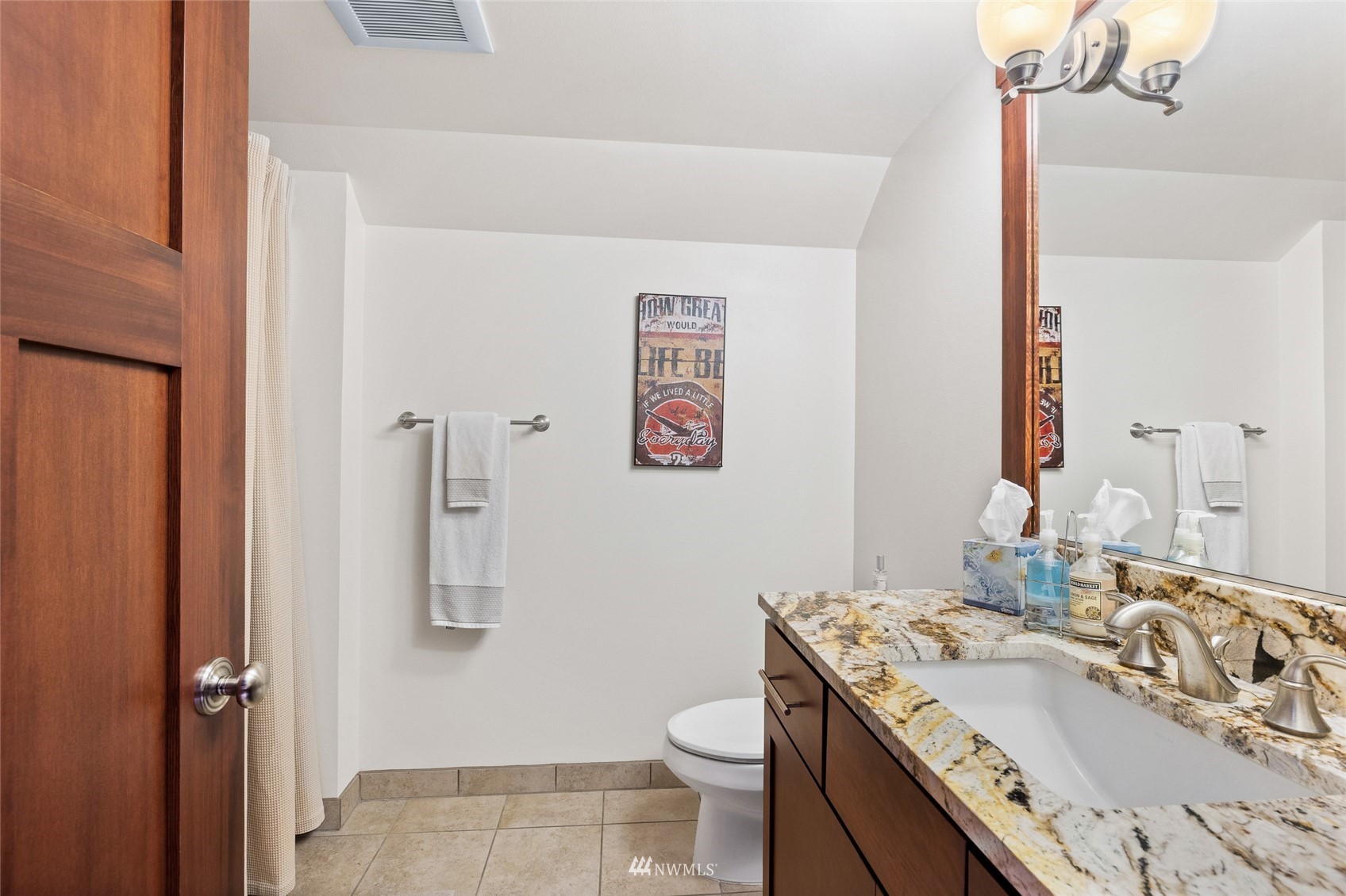 691 Kachess River Road Easton, WA 98925 - Photo 33 of 40 a bathroom with a granite countertop sink toilet and a mirror