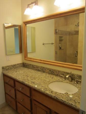 3566 Modoc Road, Unit 36 Santa Barbara, CA 93105 - Photo 8 of 16 a bathroom with a granite countertop sink and a mirror