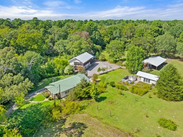 an aerial view of a house with a yard