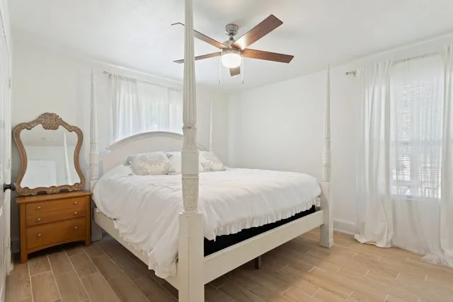 a bedroom with a bed and a chandelier