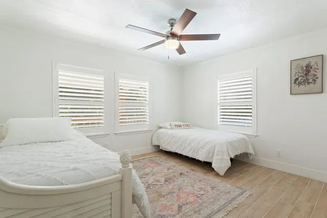 a spacious bedroom with a bed and a window