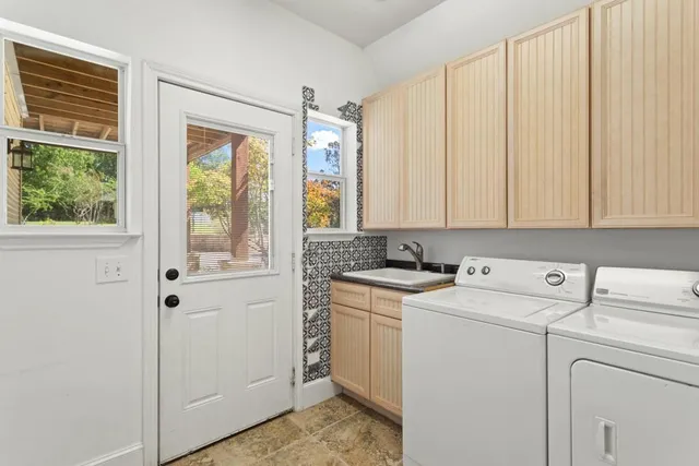 a view of washer and dryer with kitchen in the background