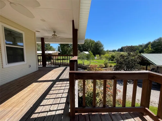 a view of balcony with wooden floor and seating space