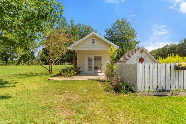 a front view of a house with yard and garage